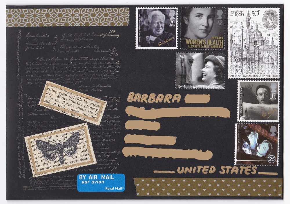 Gold writing and background stamp on a black mailer with co-ordinating postage stamps
